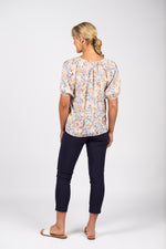 Woman wearing a floral blouse and navy pants on a white background
Printed V Neck Top Amalfi