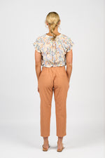 Woman wearing a floral blouse and orange pants on a white background
Skinny Leg 7/8 Pants Spice